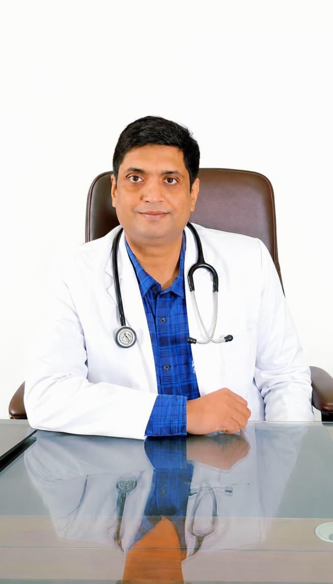 Dr. Saurabh Tripathi, Consultant Paediatrician and Paediatric Endocrinologist, in a white coat with a stethoscope.